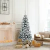 A decorated Christmas tree with presents in a living room setting. Produktbild-Vorschau