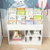 A white bookshelf filled with children's books and toys, set against a wall with a mural of an astronaut. Náhled obrázku produktu