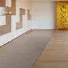 A long, narrow rug is placed on a light wooden floor in a modern hallway with built-in shelving. Produktbild-Vorschau