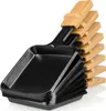 A stack of black raclette pans with bamboo handles, presented against a white background. Produktbild-Vorschau