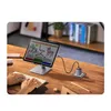 A tablet is connected to a charger on a wooden desk, with a keyboard in the foreground. Voir les images du produit