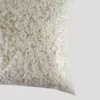 A close-up of white foam flakes in a clear plastic bag against a light gray background. Produktbild-Vorschau