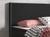 A close-up view of a bed with pillows and bedding. Produktbild-Vorschau