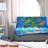 A Minecraft-themed blanket is draped over a sofa in a living room setting. Anteprima dell’immagine prodotto