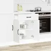 A white kitchen cabinet with its doors open, revealing pots inside. A drawer is partially open above the cabinet doors. The background shows a tiled wall and a kitchen counter with bottles and an oven. Produktbild-Vorschau