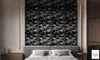 A bedroom scene with a bed, textured wall panels, and lighting. Produktbild-Vorschau