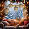 A cozy living room scene with a couch, pillows, and a cup of coffee, set against a window with a snowy winter landscape and illuminated Christmas ornaments. Náhled obrázku produktu