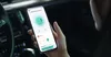 A person holding a smartphone inside a car, displaying an air purifier app. Produktbild-Vorschau
