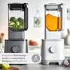 Two high-performance blenders are shown side-by-side in a kitchen setting. One blender contains green vegetables, and the other contains an orange liquid. A text overlay describes features. Produktbild-Vorschau