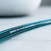 A close-up shot of a garden hose with branding and product details visible. Voir les images du produit