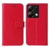 A red flip phone case with a floral and butterfly design is shown open and closed. Produktbild-Vorschau