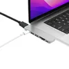 A close-up shot of a USB-C hub connected to a laptop, with cables plugged into it. Produktbild-Vorschau