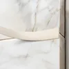 A close-up shot of a bronze-colored PVC flat profile with adhesive, applied to a marble-patterned surface. Anteprima dell’immagine prodotto