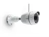 A white outdoor security camera with an antenna is mounted on a white wall. Produktbild-Vorschau