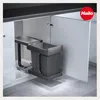 A pull-out trash bin system installed under a kitchen counter. Voir les images du produit