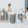 A mother and daughter are doing laundry together in a bright, modern laundry room. Náhled obrázku produktu