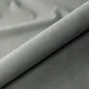 A close-up, rolled-up view of gray fabric, likely a bed frame or mattress. Produktbild-Vorschau