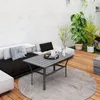 An outdoor patio scene with a coffee table, sofa, and plants. Náhled obrázku produktu
