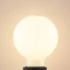 A close-up shot of a white, globe-shaped LED light bulb with a black base. Produktbild-Vorschau