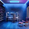 A modern gaming room with a desk, chair, computer, and ambient lighting. Produktbild-Vorschau