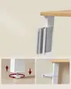 Collage showing details of a bookshelf, including a leg with adjustable feet, a wall mounting strap, and the top corner of a bookshelf with books. Produktbild-Vorschau