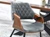 A close-up of a modern dining chair with a gray upholstered seat and back, and a walnut-finished wooden frame. Náhled obrázku produktu