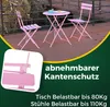 A pink metal bistro set with a table and two chairs on a wooden deck, with promotional text overlays. Produktbild-Vorschau