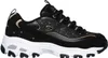 A side view of a black Skechers sneaker with gold accents and a white sole. Voir les images du produit