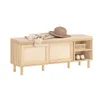 A wooden shoe bench with a cushioned seat, featuring sliding doors and open shelving for shoe storage. A hat and scarf are placed on the seat. Produktbild-Vorschau