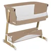 A beige and white baby crib with wooden legs is shown against a white background. Náhľad obrázku produktu