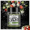 Bagatzounis Griechisches Salatgewürz im Glas mit fliegenden Zutaten eines griechischen Salats Produktbild-Vorschau