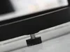 A close-up of the adjustable foot of a black furniture piece, likely a table or chair, resting on a light-colored surface. Náhľad obrázku produktu