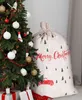 A Christmas tree with ornaments and gifts next to a large Santa sack. Podgląd zdjęcia produktu