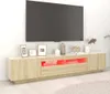 A modern TV stand with LED lighting is shown in a living room setting. Náhled obrázku produktu