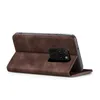 A brown flip case for a smartphone is shown from the side, with the phone partially inserted. Produktbild-Vorschau