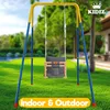 A baby swing set is shown in a backyard setting with a house in the background. Produktbild-Vorschau