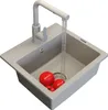 A granite sink with a faucet running water into it, and three tomatoes inside. Produktbild-Vorschau