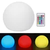 A white spherical LED light and a remote control are shown, along with three examples of the light in different colors (blue, red, and yellow). Podgląd zdjęcia produktu