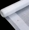 A close-up shot of a white, rolled-up material with a grid pattern, set against a black background. Produktbild-Vorschau
