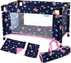 A doll's travel crib with accessories laid out around it. Produktbild-Vorschau