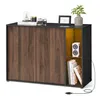 A modern sideboard with wood-grain doors and an open shelving unit with yellow backlighting. Produktbild-Vorschau