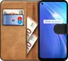 A brown leather wallet case with a smartphone inside, showing cards and euro banknotes. Produktbild-Vorschau