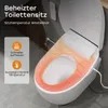 A close-up view of a smart toilet seat with heating elements highlighted in orange, placed on a white toilet bowl in a bathroom setting. Produktbild-Vorschau