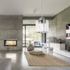 A modern living room with a fireplace, concrete walls, and a pendant lamp. Produktbild-Vorschau