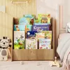 A wooden bookshelf filled with children's books, placed next to a child's bed. Podgląd zdjęcia produktu