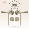 A marketing image showcasing door handles and keyhole escutcheons, framed by an arched doorway graphic. Produktbild-Vorschau