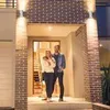 A couple stands in front of a modern house entrance. Náhled obrázku produktu