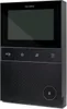 A black DoorBird IP video intercom station is shown from a slightly angled front view against a black background. Produktbild-Vorschau