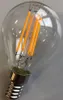 A close-up studio shot of an LED filament light bulb. Produktbild-Vorschau