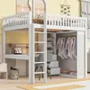 A loft bed with a desk, closet, and shelves integrated into its structure, set in a child's bedroom. Produktbild-Vorschau